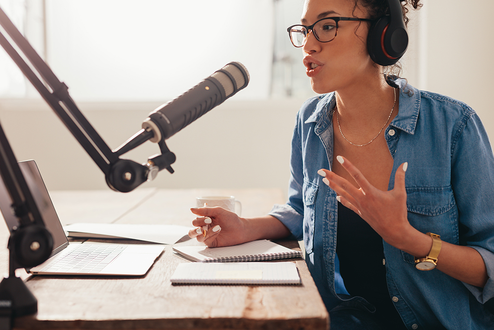 Woman recording and broadcasting her podcast from home